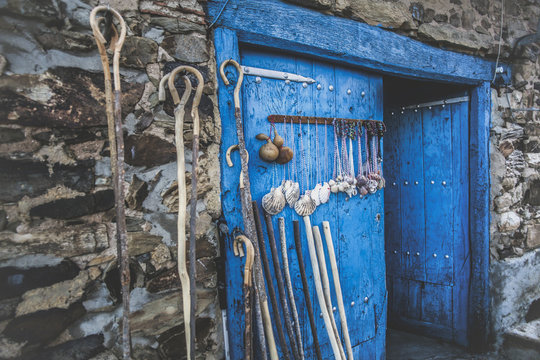 Blue door with sticks and seashells on the wall