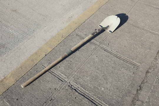 Shovel on urban sidewalk