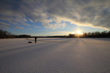 Ice fishing on the lake in the early morning. Canada