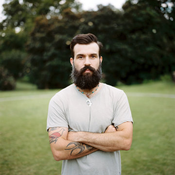 Portrait of a tattooed man with a big beard