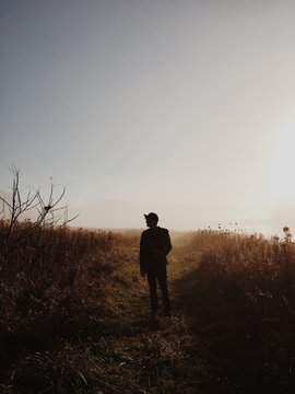 Silhouette of a man on an early morning hike