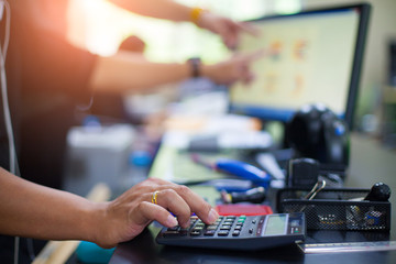 Business man using calculator with doing finance at his office.