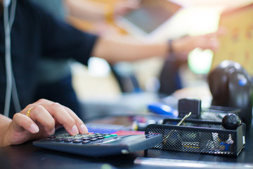 Business man using calculator with doing finance at his office.