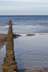 Shot of wooden groins on the island Poel, Baltic Sea, Germany