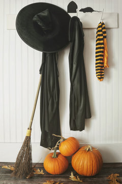 Halloween costumes hanging on hooks