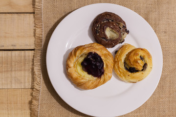 a variety of bakery on wooden plate