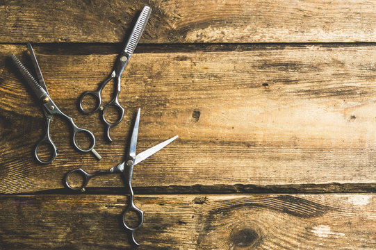 Hair accessories such as scissors On the old wood desk in a professional hairdresser from above, the text area. Vintage Ideas