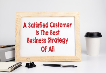 A Satisfied Customer Is The Best Business Strategy of All. Office table with wooden frame.
