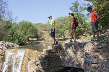 Young Travelers, hikers near a waterfall