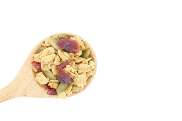 granola cereal in wooden spoon on white background