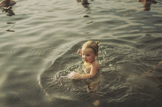Child learning to swim in the ocean