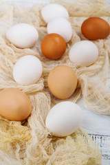 Farm producst, raw hen eggs on white wooden table. Copy space