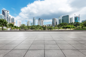 empty brick floor with modern buildings