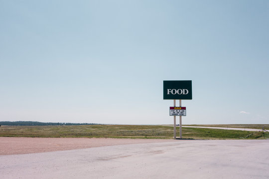 Malplaced large commercial sign saying "Food" in the middle of nowhere