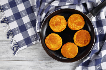 tasty  pumpkin pancakes on iron skillet