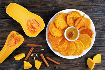 golden yellow pumpkin pancakes with honey