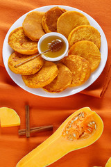 pumpkin pancakes with honey on platter