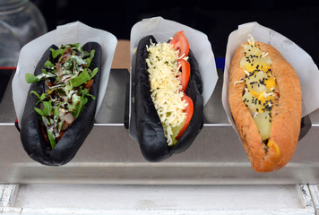 Black hot dogs selling on the street. Street food