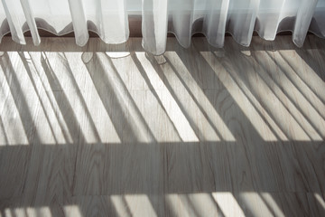 moring light shading the white and create a shadow pattern on the floor