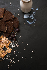 Food composition of bakery products, close up top view. Wholegrain sort of breads and bottle of milk, free space. Local market and degustation concept