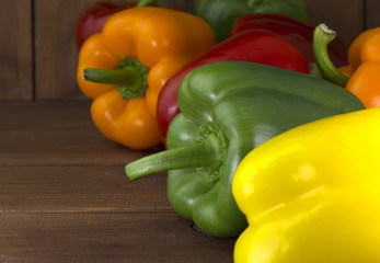 Juicy beautiful Bulgarian pepper on a wooden background