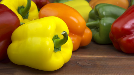 Juicy beautiful Bulgarian pepper on a wooden background