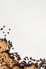 Wholegrain chocolate scone with coffee grains on white background, top view with free space. Delicious cookies and culinary art of coffeehouse concept