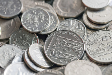 Selection of low denomination British coins in a pile. Twenty pence, ten pence and five pence coins.