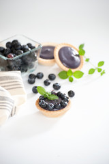 Tartlets with blueberry cream, decorated with fresh berries..