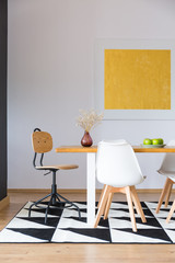 Yellow paiting hanging over table