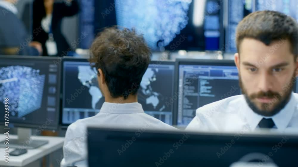 Poster Neural Network and Machine Learning Engineer Working at His Workstation. Multi-Ethnic Specialists Work in the Office. Multiple Displays Show Neural Network Representation.