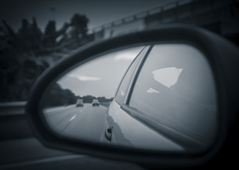 Unusual view of the highway from reflection on rearview