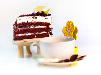 cup of coffee and delicious cake on white background