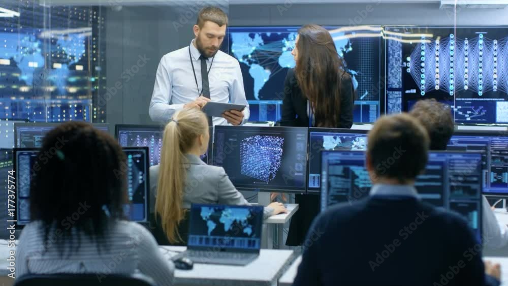Poster Project Manager and Head of the Department Hold Briefing for a Team of Engineers and Programmers that are Building Machine Learning System. Displays Show Working Model of Neural Network. 