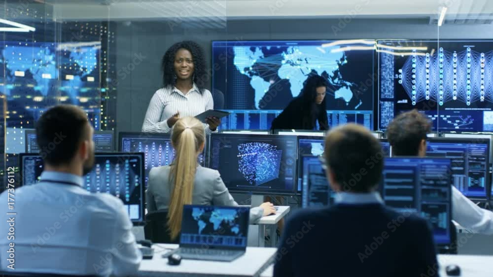 Poster Chief Project Engineer Holds Briefing for a Team of Scientists that are Building Machine Learning System. Displays Show Working Model of Neural Network. 