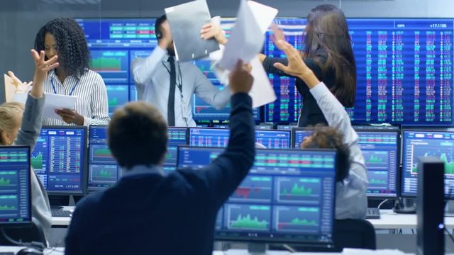 Multi-Ethnic Team of Traders Have Successful Day at the Stock Exchange Office. Dealers and Brokers Buy and Sell Stocks on the Market, they Celebrate Profitable Transaction. 