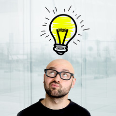 Portrait of a businessman searching good idea with bulb lamp over his head - Imagination concept