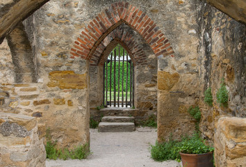 rock archway to gated entrance