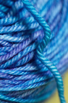 Macro of variegated blue spool of yarn