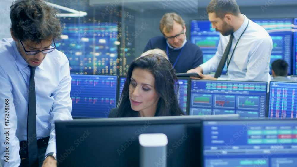 Poster multi-ethnic team of stock traders at the stock exchange firm office is busy selling and buying bond