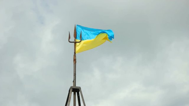 flag and coat of arms Ukraine waving in wind. Mount Cook, Carpathian Mountains.