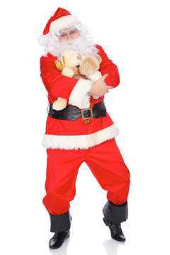 Santa Claus keeping teddy bear isolated on white background. Full length portrait