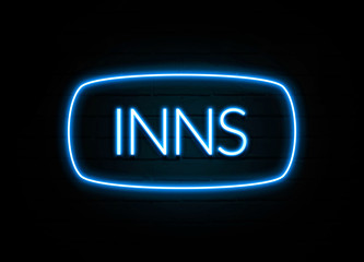 Inns  - colorful Neon Sign on brickwall