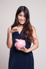 Fototapeta na wymiar Asian woman with coin and pig coin bank.