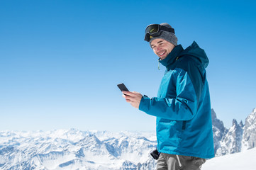 Man using smartphone in mountain