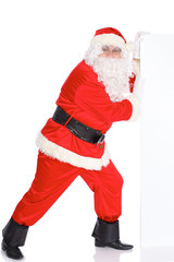 Santa Claus pushes blank white wall, advertisement banner with copy space. Isolated on white background. Full length portrait