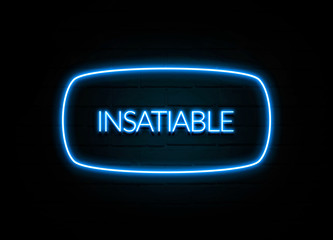 Insatiable  - colorful Neon Sign on brickwall