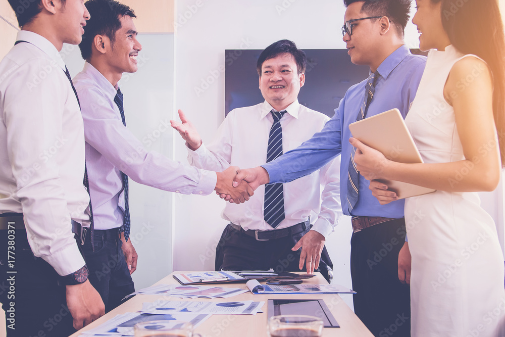 Wall mural business partners hand shake in business meeting. co-operation concept