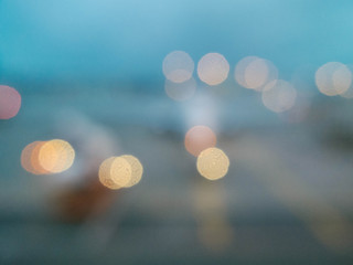 Bokeh out of focus lights looking out at airplane on runway