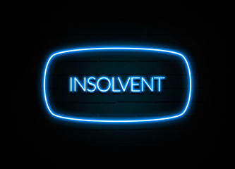 Insolvent  - colorful Neon Sign on brickwall